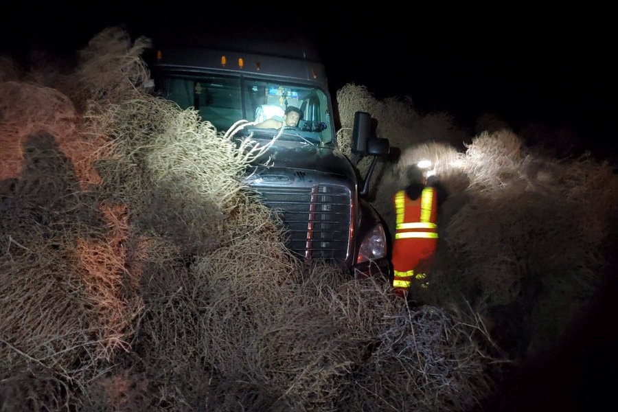 Semi-truck covered in tumbleweed during tumblegeddon